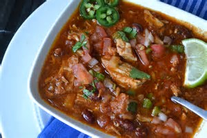 photo of pork, jalapenos, and tomatoes in a stew in a bowl