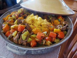 photo of meat, vegetables, and couscous in a tagine