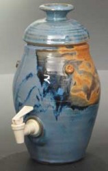 photo of a blue and brown vinegar crock with a white spout