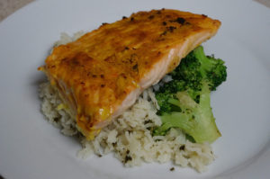 photo of a fosh fillet on top of rice and broccoli