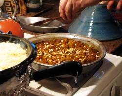 photo of food cooking on the stove in a tagine