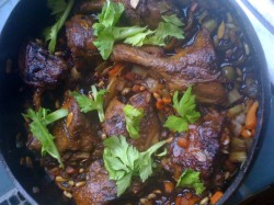 photo of baked duck and vegetables in a pot