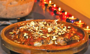 photo of chicken and tomatoes in a tagine on a stove