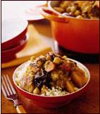 photo of turkey tagine on top of rice in a red bowl