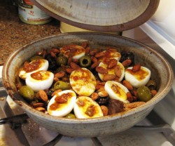 photo of split hard boiled eggs on top of a tagine in a tagine