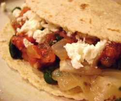 close up photos of tacos with tomatoes and carmelized onions coming out the top