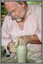 photo of an old man scuplting on the pottery wheel