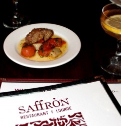 photo of a plate of steak and tomatos in a white sauce with a menu from saffron's restaurant and lounge