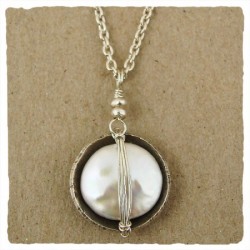 close up photo of a pearl pendant necklace