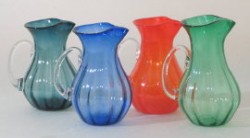 photo of 4 blown glass pictures - one teal, one blue, one orange, and one green