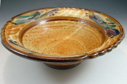 photo of a yellow and brown ceramic bowl