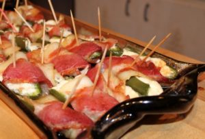 photo of bacon wrapped cheese stuffed jalapenos on a ceramic tray