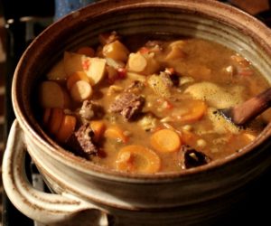 photo of a ceramic dutch oven with beef stew in it