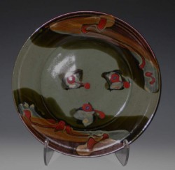 photo of a ceramic plate that is green, red, and brown