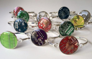 photo of a dozen metal bracelets with motherboard chip pendents