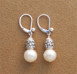 photo of silver earrings with pearls