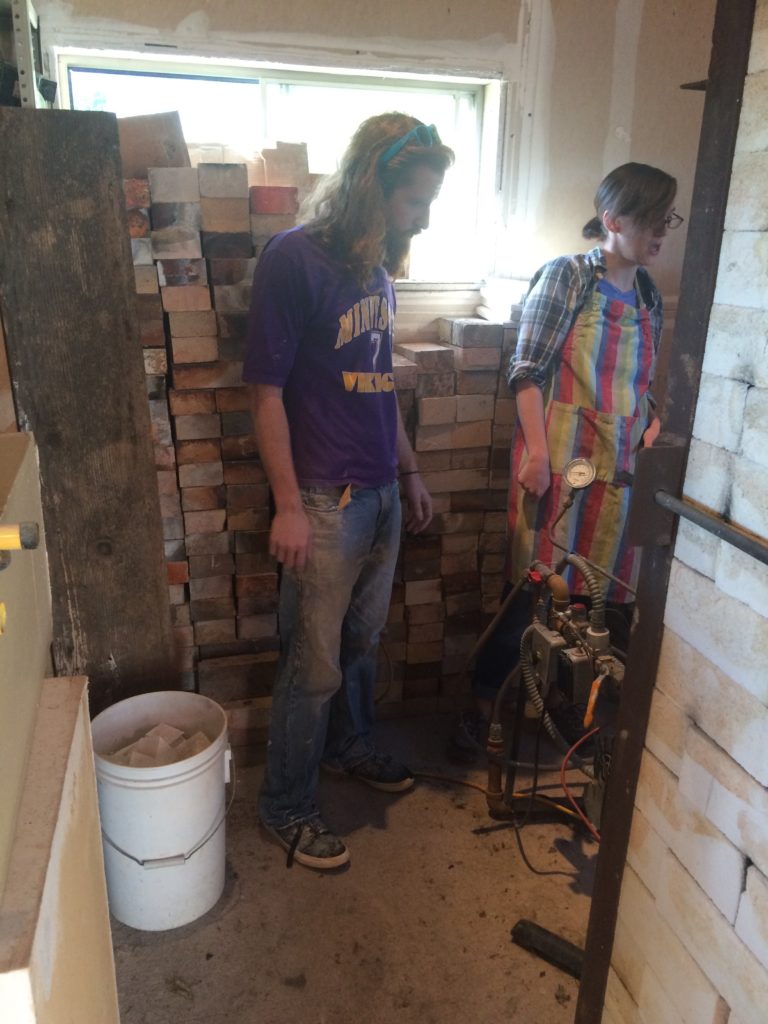 Levi Yankosky and Katie Teesdale getting ready to light the gas kiln. 