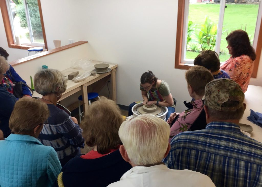 Katie Teesdale throwing pots for group tour