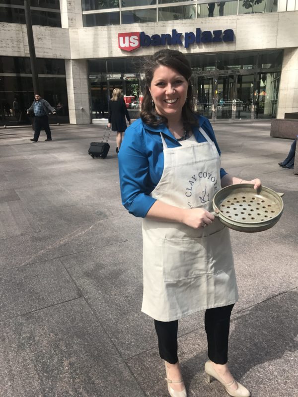 Morgan Baum, Owner & CEO of Clay Coyote Pottery, with a Grill Basket at the US Bank Building for Pitch Day