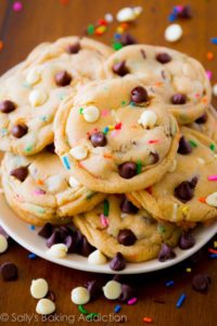 photo of a plate of small chocolate chip cookies with rainbow sprinkles