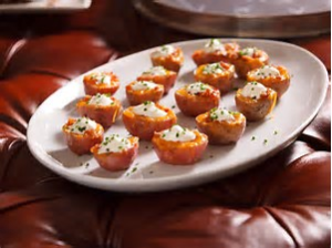 photo of small baby red potatoes loaded with cheese, sour cream, and chives