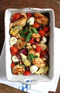 photo of baked chicken and vegetables in a casserole dish