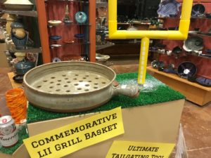 photo of a super bowl 52 commemorative grill basket next to a small yellow field goal post