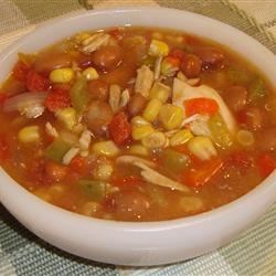 photo of a mexican soup with chicken, corn, and other vegetables in a bowl
