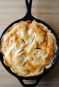 photo of an apple pie made in a cast iron skillet