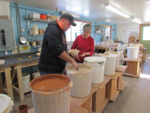 photo of joe nagel and betsy mixing glazes