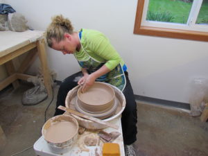 Kylie Rieke throwing in the Clay Coyote Studio