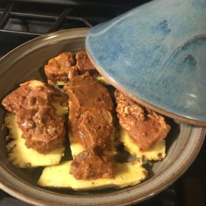 Uncovered tagine with al pastor inside