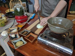 Morgan cooking saag paneer in the Clay Coyote Gallery