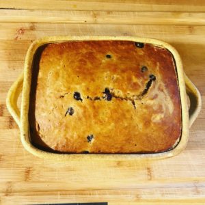 Blueberry Lemon Spice Banana Bread in a clay coyote square baker