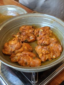 Chicken coated in spices in a Clay Coyote Tagine bottom