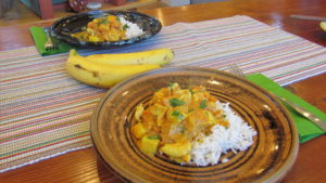 Digaag qumbe over white rice served with bananas