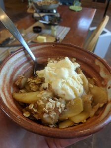 Stovetop apple crisp with vanilla ice cream, plated and ready to enjoy