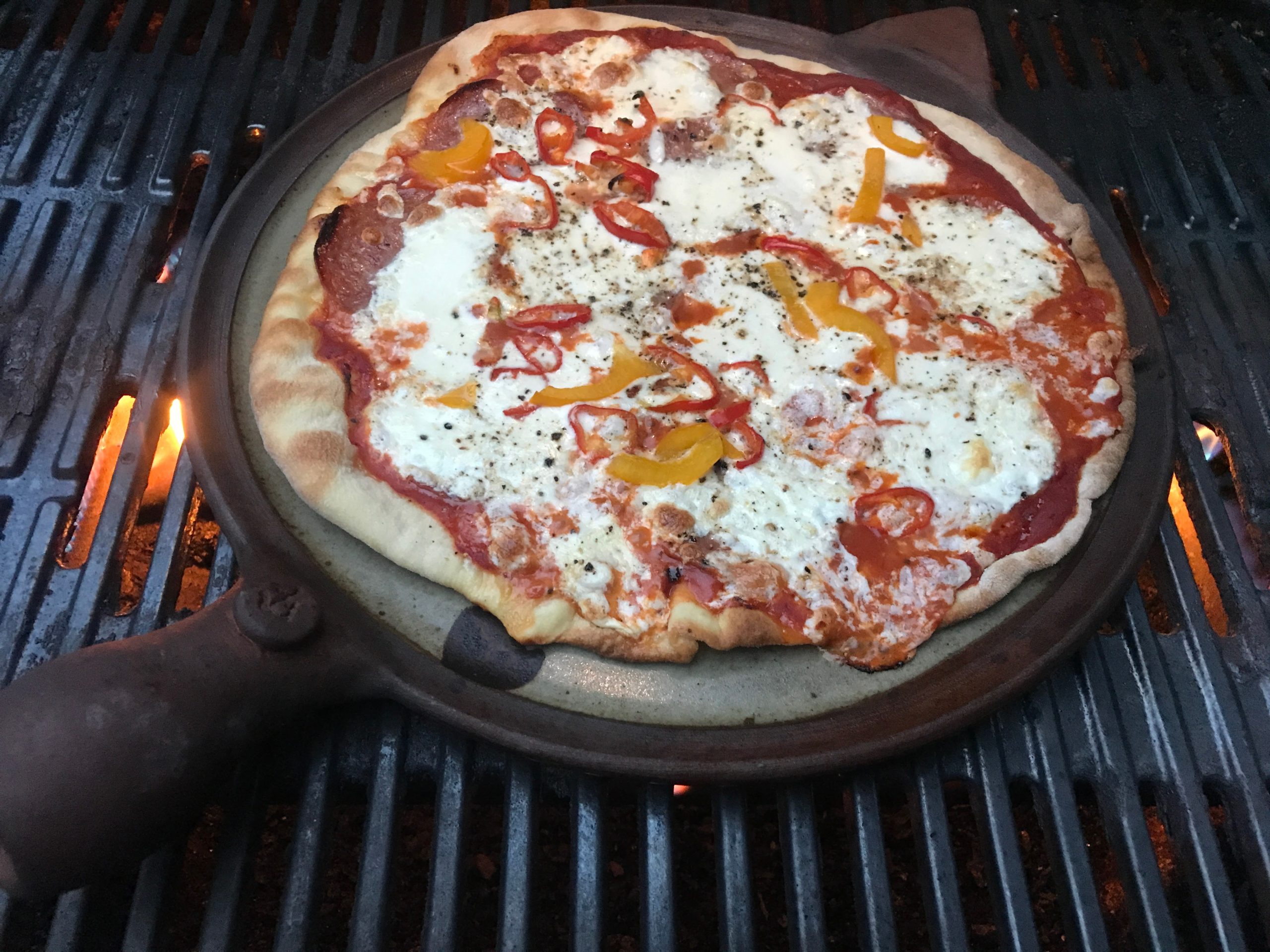 Clay Coyote Flameware Pizza Stone on the Grill