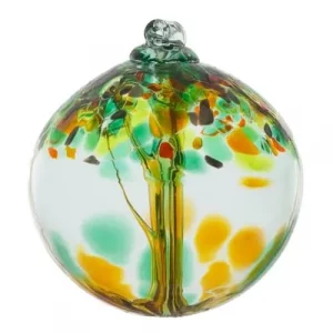 Kitras Prosperity a vertically framed photograph shows a Kitras "Prosperity" version of their hanging glass tree ornaments. The glass ball is photographed on an all white background with clear white light. there is nothing else in the photograph besides the glass ball. inside of the glass ball, the glass has been shaped to resemble a tree, and the upper half of the glass ball has been designed to look like a tree canopy. the prosperity style shown here has orange, dark green and light green "leaves". at the top of the sphere there is small circular tube to hang the piece from.