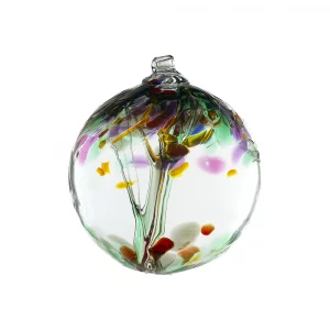 Kitras Remembrance a vertically framed photograph shows a Kitras "Remembrance" version of their hanging glass tree ornaments. The glass ball is photographed on an all white background with clear white light. there is nothing else in the photograph besides the glass ball. inside of the glass ball, the glass has been shaped to resemble a tree, and the upper half of the glass ball has been designed to look like a tree canopy. the remembrance style shown here has purple, brown, green, blue and darker yellow "leaves". at the top of the sphere there is small circular tube to hang the piece from.