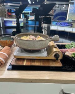 October 2022 Clay Coyote featured on WCCO Saturday Morning Show cooking with seasonal apples, pork, and pesto in a flameware cazuela and grill basket