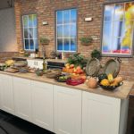 October 2022 Clay Coyote featured on WCCO Saturday Morning Show cooking with seasonal apples, pork, and pesto in a flameware cazuela and grill basket