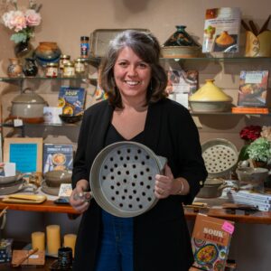 Morgan Baum, CEO & Owner of the Clay Coyote Gallery & Pottery in Hutcinson, Minnesota. Holding a Flameware Grill Basket